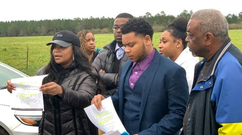 Pamela Woods, the sister of executed Alabama inmate Nathaniel Woods, holds a page from her brother’s trial transcript. She confronted the state governor Thursday.