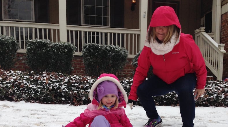 East Cobb resident Reagan Goodnough and her daughter Hattie, 3, sled in their front yard. JAIME SARRIO / JSARRIO@AJC.COM