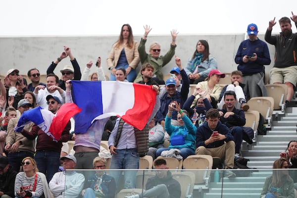 Fans cheer during the first round match of the French Tennis Open between France's Arthur Fils and Chile's Nicolas Jarry, at the Roland-Garros stadium, in Paris, Monday, May 26, 2025. (AP Photo/Lindsey Wasson)