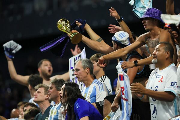 Argentina fans celebrate their 2-0 win with a replica of the World Cup Trophy after Argentina’s match against Canada in the 2024 Copa America at Mercedes-Benz Stadium, Thursday, June 20, 2024, in Atlanta. (Jason Getz/AJC)
