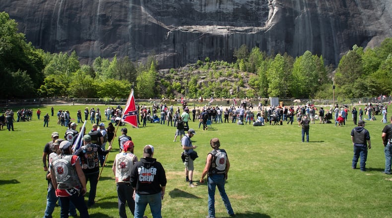 People gather on the lawn in front of the 90-foot tall carving of Stonewall Jackson, Robert E. Lee and Jefferson Davis at Stone Mountain State Park during the Sons of Confederate Veterans rally Saturday, April 30, 2022. (Photo: Steve Schaefer / steve.schaefer@ajc.com)