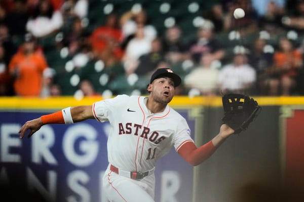 Houston Astros right fielder Cam Smith catches a foul ball hit by Seattle Mariners' Ben Williamson during the eighth inning of a baseball game in Houston, Thursday, May 22, 2025. (AP Photo/Ashley Landis)