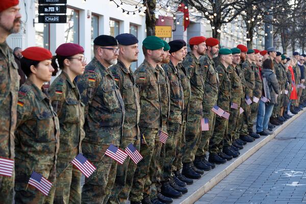 Germany's Army soldiers with U.S. national flags attend a solemn farewell ceremony at Cathedral Square in Vilnius, Lithuania, Thursday, April 3, 2025 for the US soldiers who died during training exercise. (AP Photo/Mindaugas Kulbis)