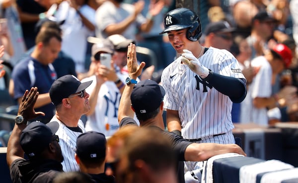 New York Yankees' Anthony Volpe is congratulated at the dugout after hitting a home run during the fifth inning of a baseball game against the Baltimore Orioles, Saturday, June 21, 2025, in New York. (AP Photo/Noah K. Murray)