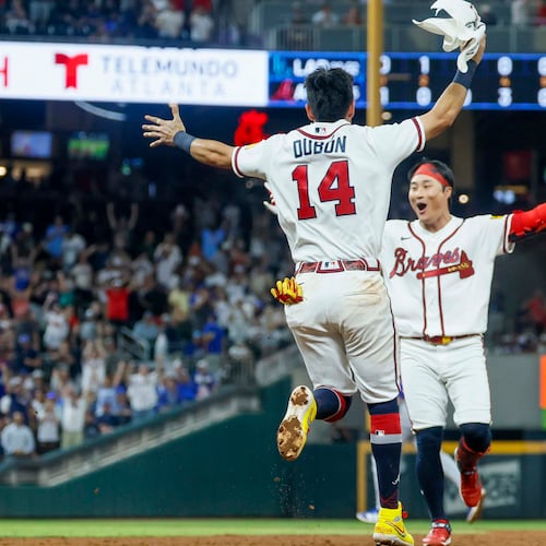 Atlanta Braves left fielder Mauricio Dubón (left) runs to celebrate with teammate Ha-Seong Kim after Kim hit a walk-off single in the ninth inning against the Los Angeles Dodgers at Truist Park in Atlanta on Wednesday, Aug. 26, 2026. The Braves defeated the Dodgers 6-5. (Miguel Martinez/AJC)