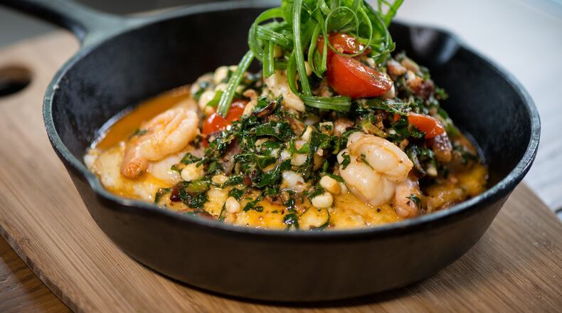 ublic School 404 Shrimp and Grits with smoky bacon and greens, blistered tomatoes, grilled corn, and beer-blanc sauce. Photo credit- Mia Yakel.
