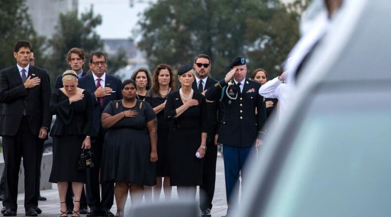 WASHINGTON, DC - SEPTEMBER 1: Members of the McCain family watch joint service members of a military casket team carry the casket of Senator John McCain from the US Capitol to a motorcade that will ferry him to a funeral service at the National Cathedral on September 1, 2018 in Washington, DC. The late senator died August 25 at the age of 81 after a long battle with brain cancer. McCain will be buried at his final resting place at the U.S. Naval Academy. (Photo by Jim Lo Scalzo-Pool/Getty Images)