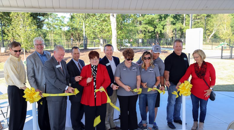 Gwinnett Commission Chairman Charlotte Nash, center, is joined by county and other officials during a ribbon-cutting celebrating a $5.6 million expansion project at Rock Springs Park.