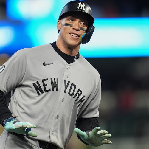 New York Yankees' Aaron Judge celebrates while running the bases after hitting a three-run home run during the eighth inning of a baseball game against the Minnesota Twins, Monday, Sept. 14, 2026, in Minneapolis. (AP Photo/Abbie Parr)