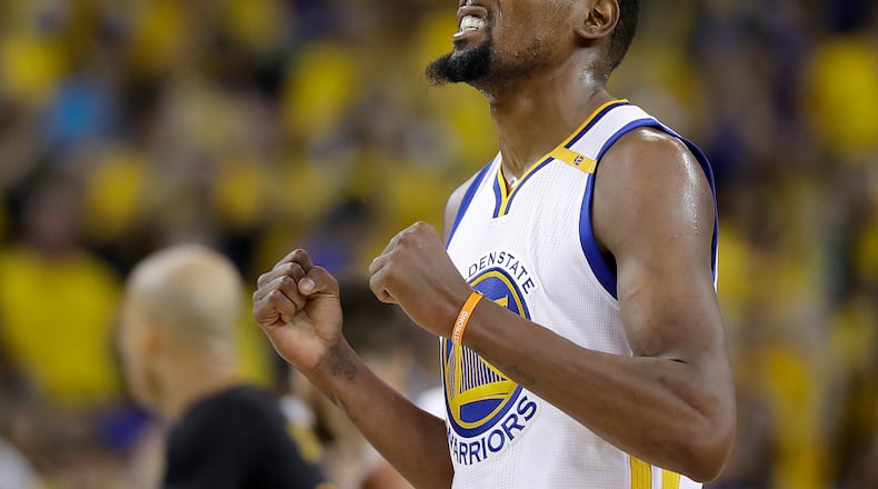 Golden State Warriors forward Kevin Durant reacts after scoring against the Cleveland Cavaliers during the second half of Monday’s Game 5 of the NBA Finals. (AP Photo/Marcio Jose Sanchez)