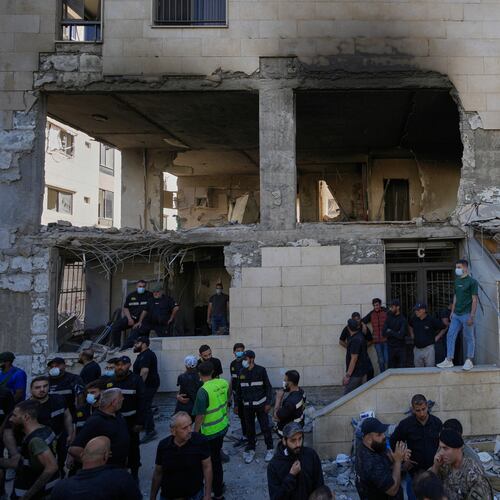 People and security officers gather in front of a destroyed apartment that was hit in an Israeli airstrike in the town of Choueifat, south of Beirut, Lebanon, Thursday, May 28, 2026. (AP Photo/Hussein Malla)