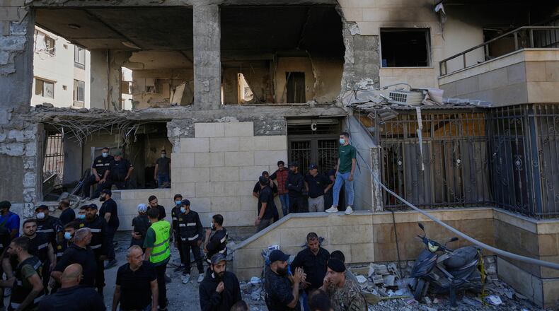 People and security officers gather in front of a destroyed apartment that was hit in an Israeli airstrike in the town of Choueifat, south of Beirut, Lebanon, Thursday, May 28, 2026. (AP Photo/Hussein Malla)