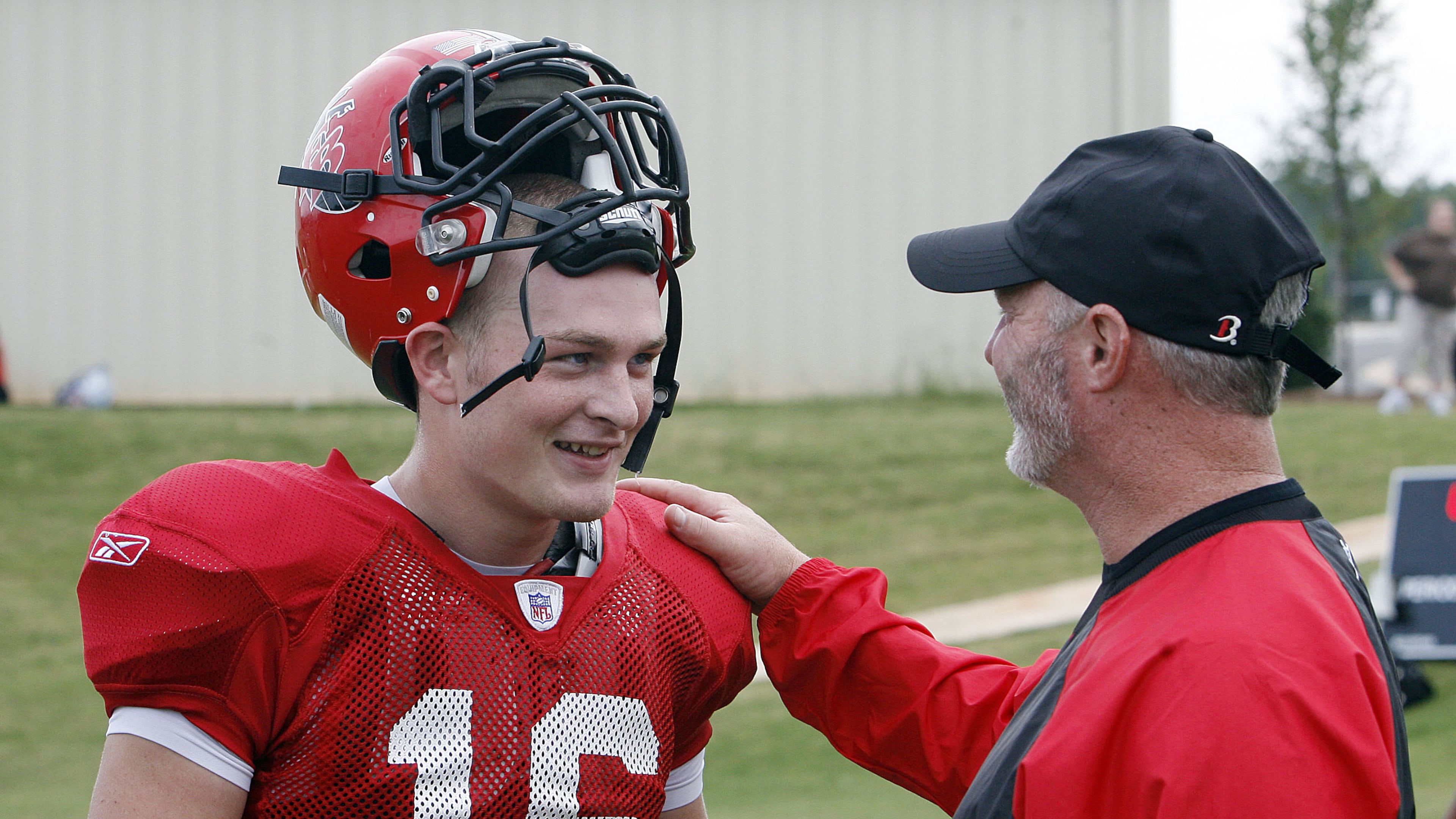 Flowery Branch High School football coach Lee Shaw (right) talks with his son, Connor, during practice. Connor Shaw was the AJC’s 2009 Class 3A Offensive Player of the Year. (Phil Skinner/AJC)