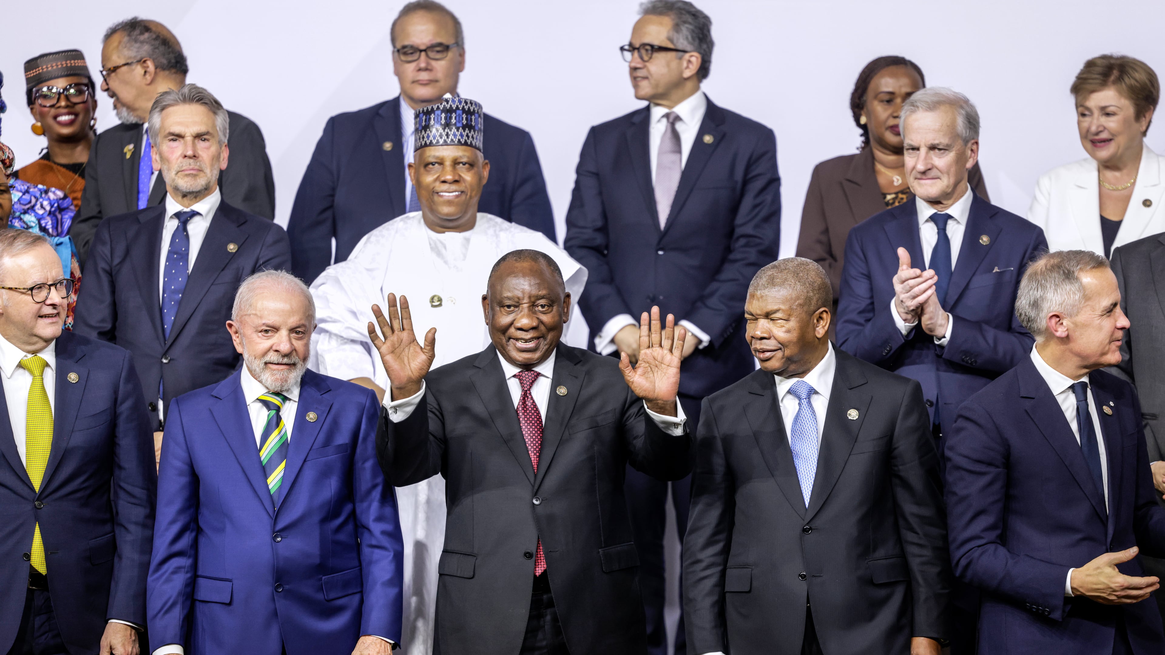 From left, front row, Australia's Prime Minister Anthony Albanese, Brazil's President Luiz Inacio Lula da Silva, South Africa's President Cyril Ramaphosa, President of Angola and Chairperson of the African Union Joao Lourenco and Canada's Prime Minister Mark Carney react as they pose a group photo, on the opening day of the G20 Leaders' Summit, in Johannesburg, South Africa, Saturday, Nov. 22, 2025. (Gianluigi Guercia/Pool Photo via AP)