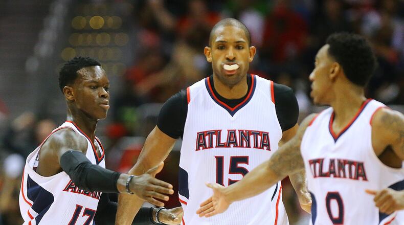 Hawks Dennis Schroder (from left), Al Horford and Jeff Teague react after a scoring play against the Nets on their way to a 96-91 victory Wednesday. Curtis Compton / ccompton@ajc.com