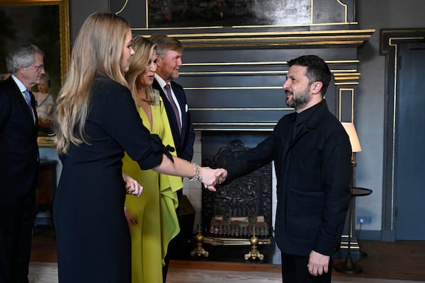 Ukraine's President Volodymyr Zelenskyy, right, is welcomed by Netherland's King Willem Alexander and Netherland's Queen Maxima as he arrives for a formal dinner at the Paleis Huis ten Bosch ahead of the NATO summit in The Hague, Netherlands, Tuesday, June 24, 2025. (Misha Schoemakers, Pool Photo via AP)