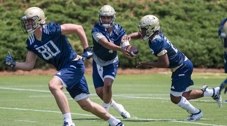 Georgia Tech quarterback Lucas Johnson (7) hands off to running back Jordan Mason (27). (Alyssa Pointer/alyssa.pointer@ajc.com)