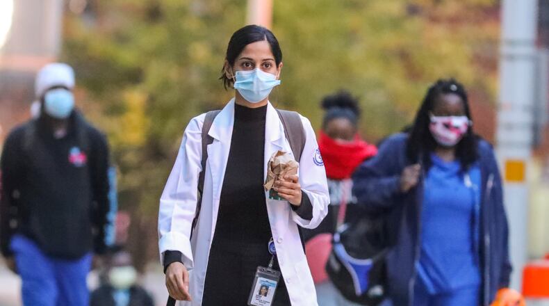 Health care workers arrive for work at Grady Memorial Hospital in Atlanta. (John Spink / John.Spink@ajc.com)