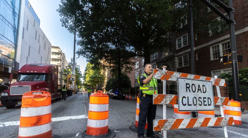 Molena, Georgia assistant police chief, Jesus Lopez helped putting up closure signage on 6th Street on Peachtree Street. A construction project that got underway on Wednesday in Midtown Atlanta closed a portion of Peachtree Street for several days, officials said.