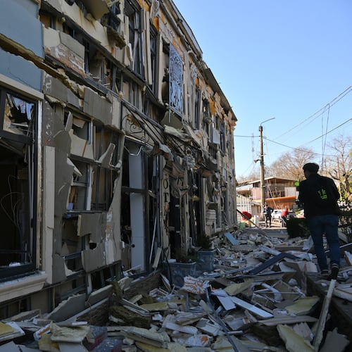 A person walks near residential houses damaged by a Russian strike in Odesa, Ukraine, Monday, April 27, 2026. (AP Photo/Michael Shtekel)