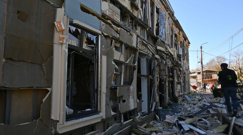 A person walks near residential houses damaged by a Russian strike in Odesa, Ukraine, Monday, April 27, 2026. (AP Photo/Michael Shtekel)