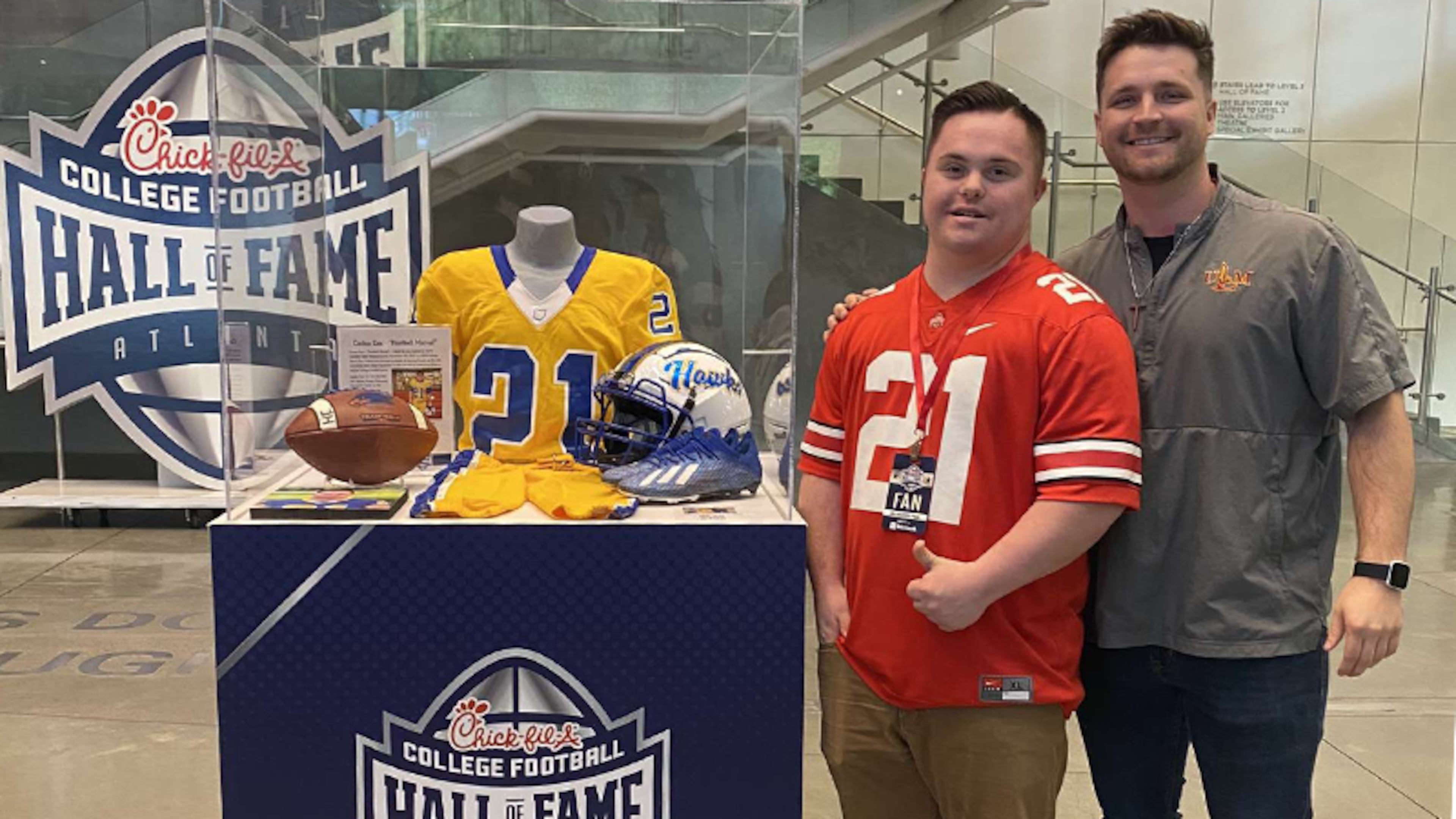 Atlanta's College Football Hall of Fame added a display in 2023 to honor Caden Cox (left, with his brother, Zane), who in 2021 became the first person with Down syndrome to play in an official college football game. (Courtesy of the Special Olympics)