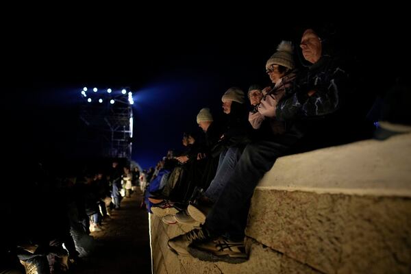 Attendees wait for the start of the "Spirit of Place" ceremony and dawn memorial service at the Anzac Cove beach, the site of the April 25, 1915, World War I landing of the ANZAC (Australian and New Zealand Army Corps) on the Gallipoli peninsula, near Canakkale, Turkey, early Friday, April 25, 2025. (AP Photo/Emrah Gurel)