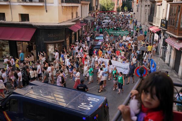 People march during a protest against overtourism in the Balearic island of Mallorca, Spain, Sunday, June 15, 2025. (AP Photo/Joan Mateu Parra)