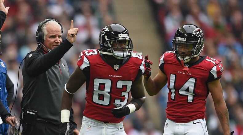 Atlanta Falcons coach Mike Smith, left, gestures during the NFL football game against Detroit Lions at Wembley Stadium, London, Sunday, Oct. 26, 2014. (AP Photo/Tim Ireland)