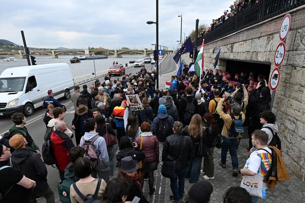 Supporters of the political party Momentum stage a protest in Budapest, Monday, April 14, 2025 after Hungary’s parliament has passed an amendment to the constitution that allows the government to ban public events by LGBTQ+ communities. (Tibor Illyes/MTI via AP)