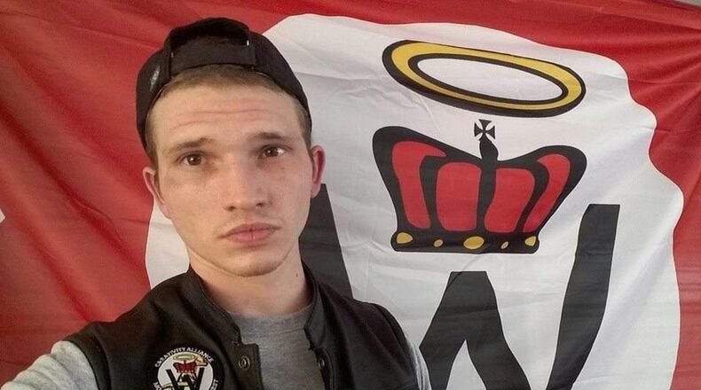 William Christopher Gibbs, arrested Feb. 2, 2017, for possession of ricin, poses in front of a flag for the Church of Creativity, a violent white supremacist pseudo-religion. The ricin charge was recently dropped on a technicality.