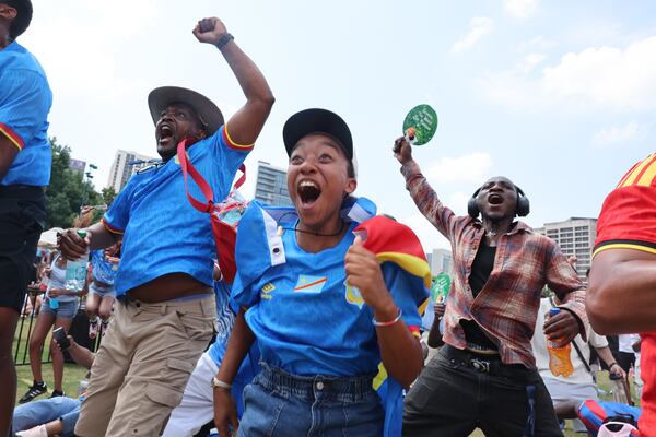 Congo fans cheer after their team scores an early goal at Fan Fest in Centennial Olympic Park in Atlanta during the England versus Congo FIFA World Cup game on July 1, 2026. The game was played in Atlanta Stadium (Mercedes Benz Stadium) in the knockout round of 32. (Arvin Temkar/AJC)
