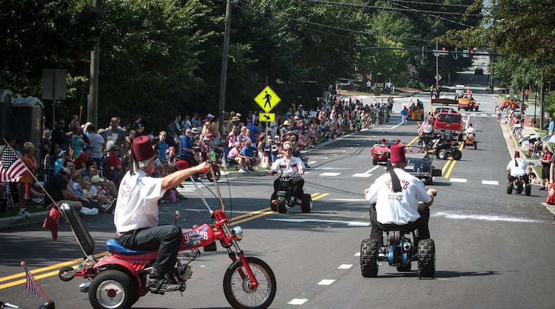 Shriners ride their scooters down Roswell Street during the Old Soldiers Day Parade in Alpharetta last year. STEVE SCHAEFER / SPECIAL TO THE AJC