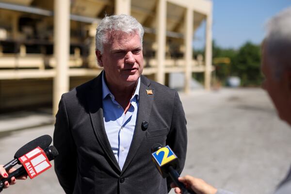 U.S. Rep. Mike Collins speaks with reporters in Norcross on Tuesday. (Jason Getz/AJC)