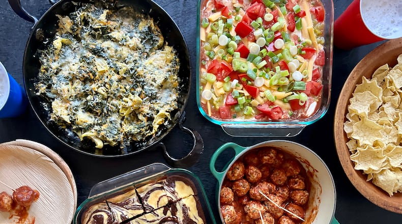 These tailgate dishes might not look out of the ordinary, but they're healthier versions of game day favorites: (clockwise from top left) Makeover Spinach and Artichoke Dip, Seven-Layer Dip, BBQ Meatballs and Chocolate Swirl Brownies. (Virginia Willis for The Atlanta Journal-Constitution)