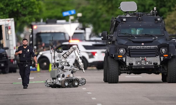 Law enforcement officials investigate after an attack on the Pearl Street Mall Sunday, June 1, 2025, in Boulder, Colo. (AP Photo/David Zalubowski)
