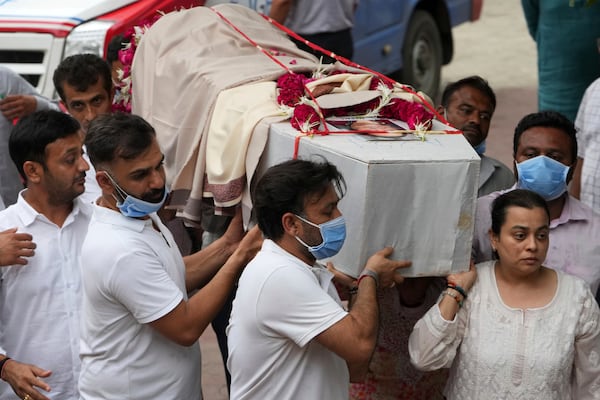 Family members carry coffin of Meena Patel, victim of the Air India plane crash, during his cremation at a crematorium in Ahmedabad, India, Monday, June 16, 2025. (AP Photo/Ajit Solanki)