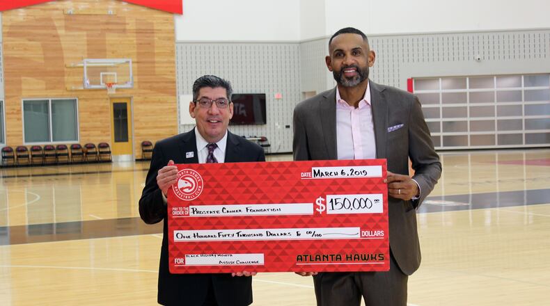 Hawks Vice Chair Grant Hill (right) presents a check for $150,000 to Jonathan W. Simons of the Prostate Cancer Foundation recently. Photo provided.