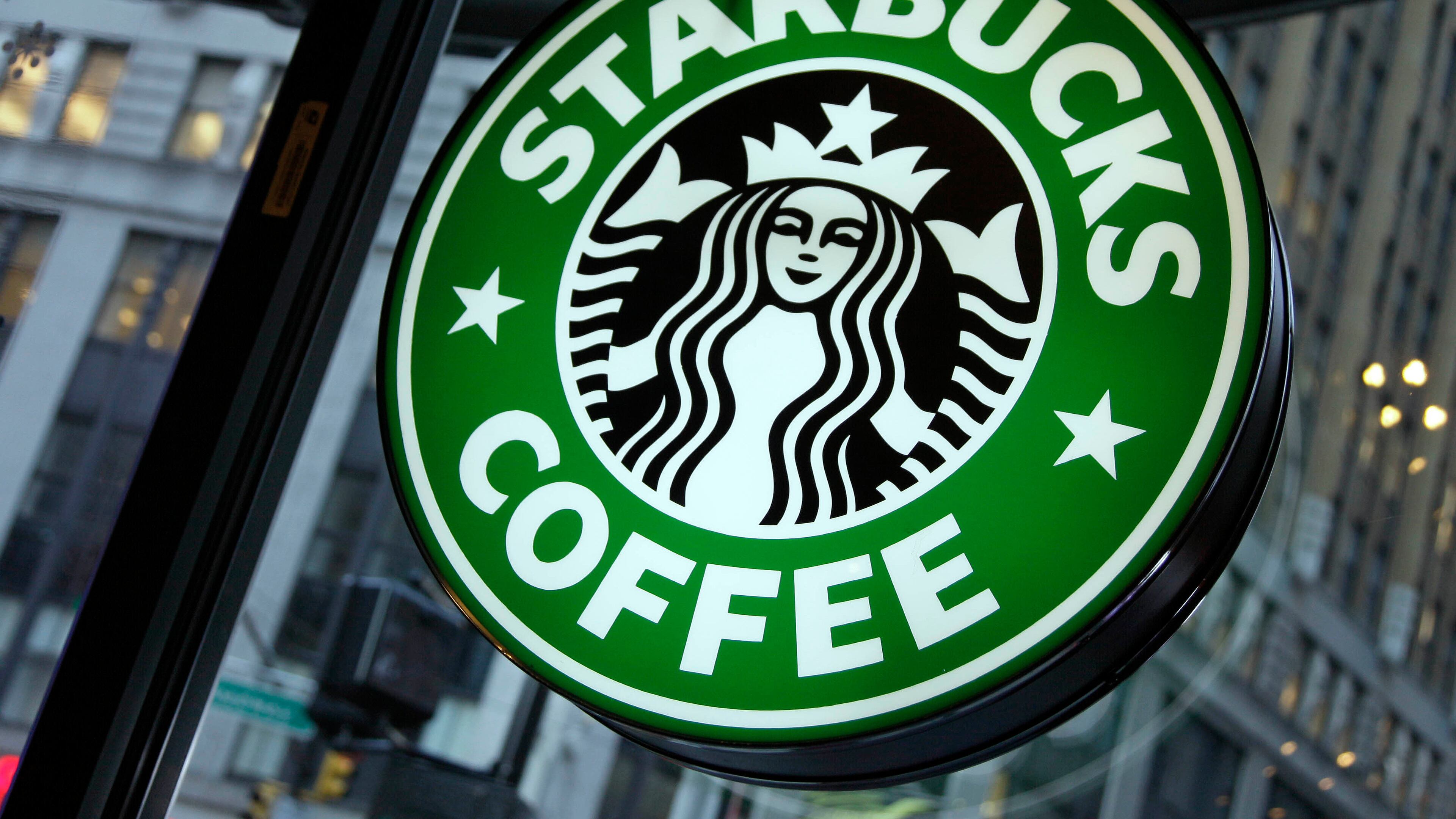 FILE - This Dec. 20, 2010 file photo shows signage at a Starbucks store in New York. (AP Photo/Richard Drew, File)