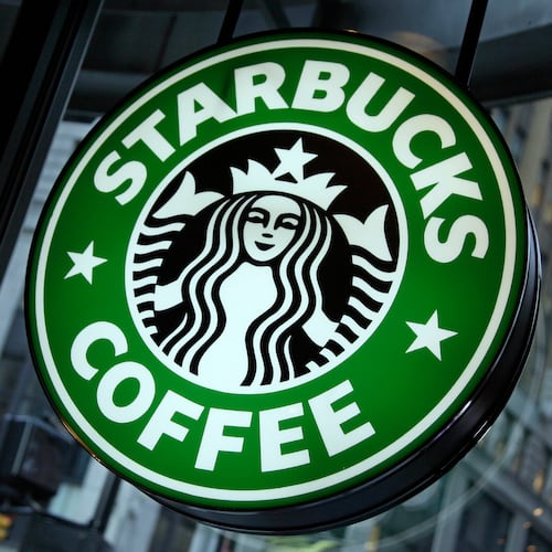 FILE - This Dec. 20, 2010 file photo shows signage at a Starbucks store in New York. (AP Photo/Richard Drew, File)