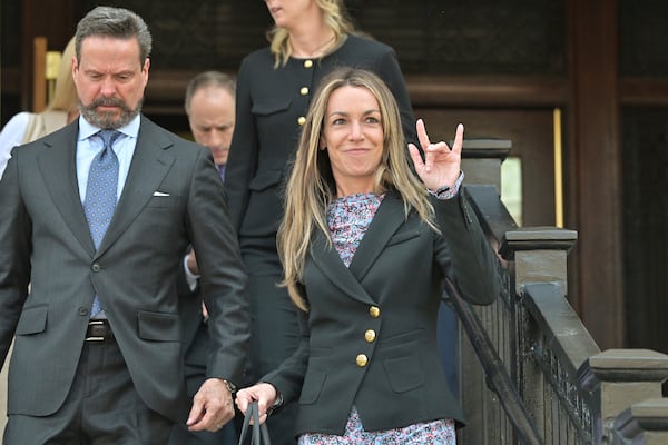 Karen Read, right, gestures to supporters as she and attorney Alan Jackson, left, leave the Dedham, Mass. courthouse, after the judge issued instructions to the jury in Read's trial at Norfolk Superior Court, Friday, June 13, 2025, in Dedham, Mass. (AP Photo/Josh Reynolds)