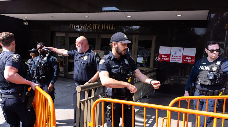 Atlanta police officers set barricades in front of City Hall as council members discussed and voted on legislation to fund construction of a public safety training center in DeKalb County, Georgia, on June 5, 2023. (Arvin Temkar/The Atlanta Journal-Constitution/TNS)