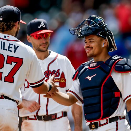 Atlanta Braves third baseman Austin Riley (27) reacts with first baseman Matt Olson, center, and catcher Drake Baldwin, right, after the team defeated the Texas Rangers in a baseball game, Sunday, July 19, 2026, in Atlanta. (AP Photo/Erik S. Lesser)