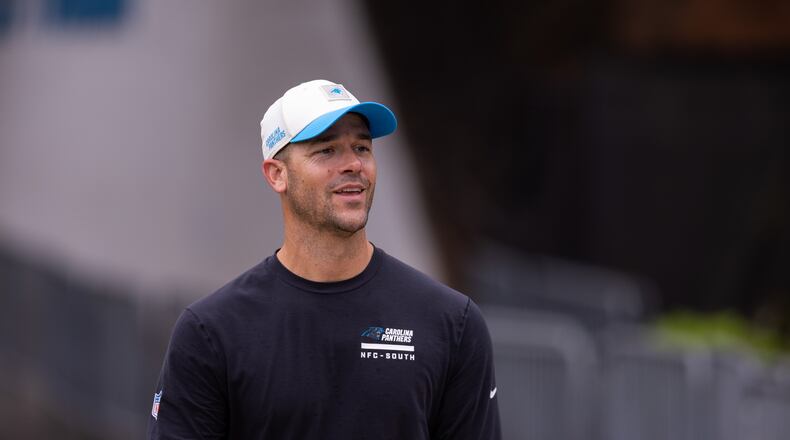 Carolina Panthers head coach Dave Canales walks up to the field forc} the NFL football team's training camp Friday, July 24, 2026, in Charlotte, N.C. (AP Photo/Scott Kinser)
