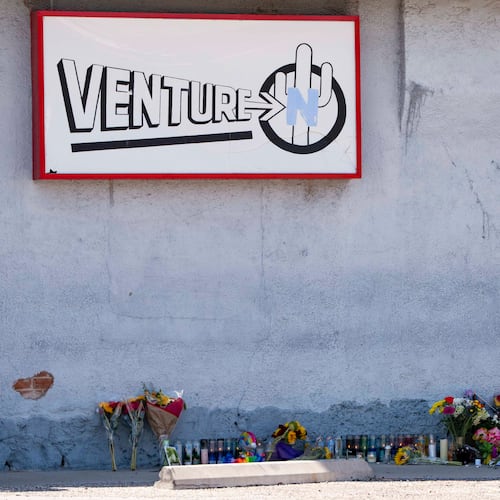 A growing memorial sits outside the Venture-N Bar in Tucson, Ariz., Tuesday, Sept. 1, 2026, for Vincent Siquieros and Cameron Capara, who were fatally shot in the parking lot of the gay bar shortly after midnight Monday. (AP Photo/Rebecca Noble)