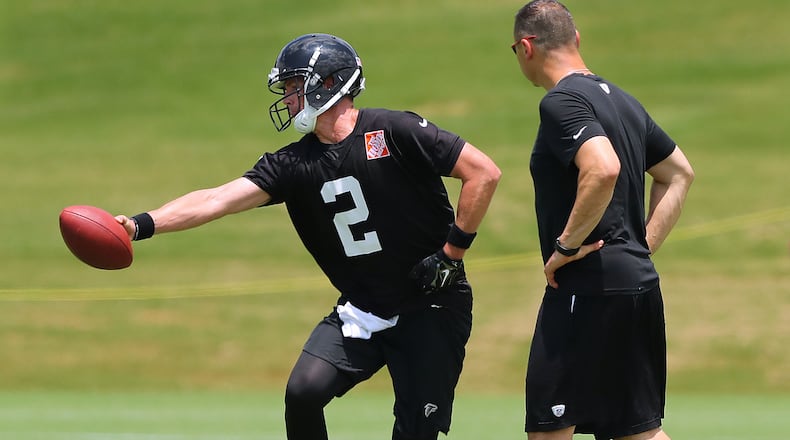 New Falcons offensive coordinator Steve Sarkisian watches quarterback Matt Ryan's technique during the first day of mini-camp Tuesday, June 13, 2017, in Flowery Branch.