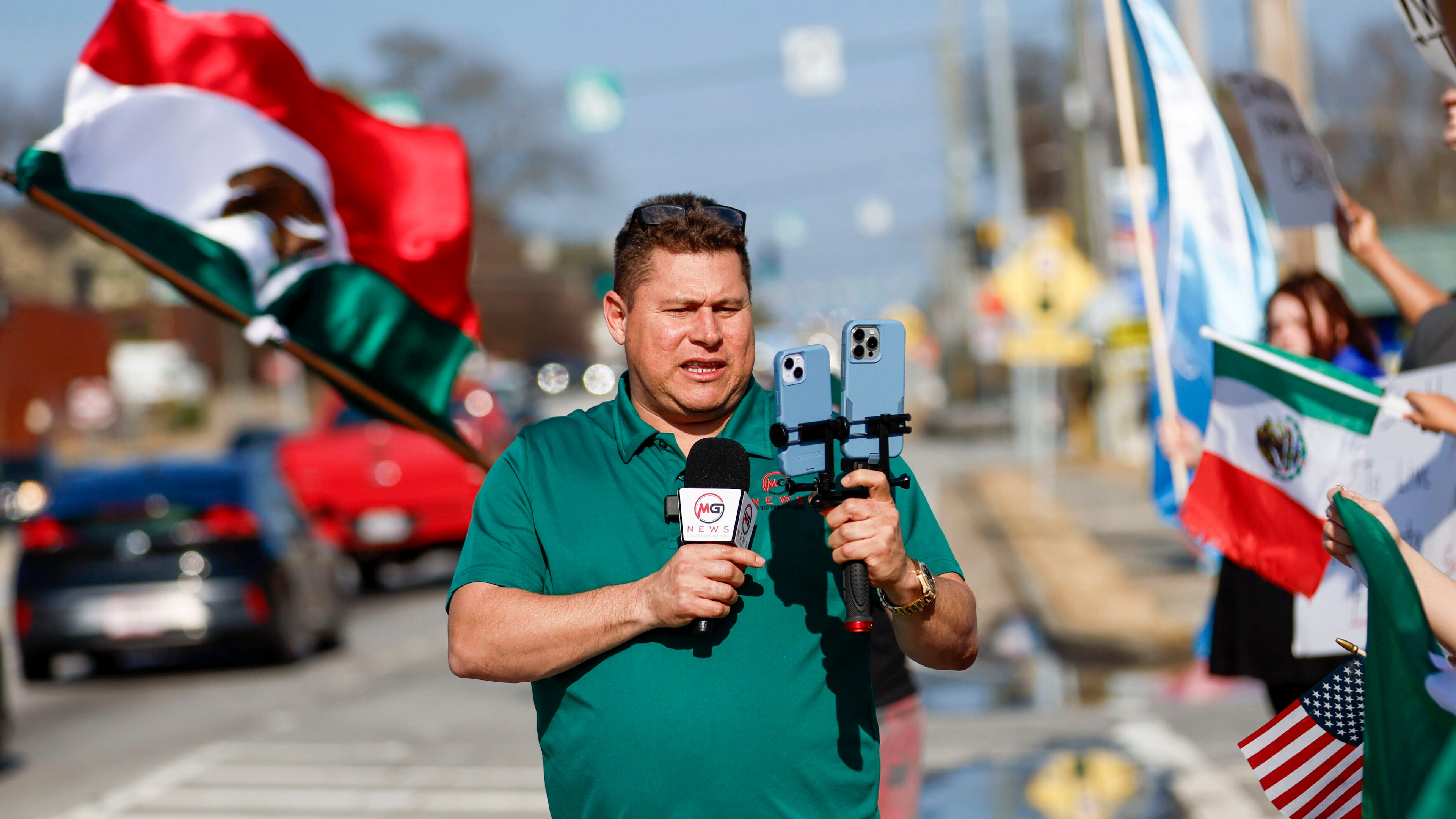 Mario Guevara, the metro Atlanta-based Spanish-language reporter, covers a protest against immigration enforcement on Buford Highway, Saturday, Feb. 1, 2025. (Miguel Martinez/Atlanta Journal-Constitution via AP)