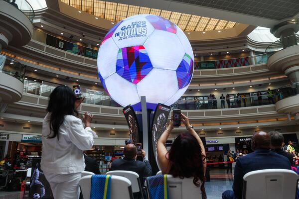 People record during the unveiling of Atlas, a new digital sphere, at Hartsfield-Jackson Atlanta International Airport on Tuesday, June 2, 2026. (Abbey Cutrer/AJC)