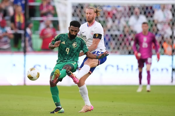 Saudi Arabia's Firas Alburaikan (9) and United States' Tim Ream (13) battle for control of the ball during a CONCACAF Gold Cup soccer match, Thursday, June 19, 2025, in Austin, Texas. (AP Photo/Eric Gay)