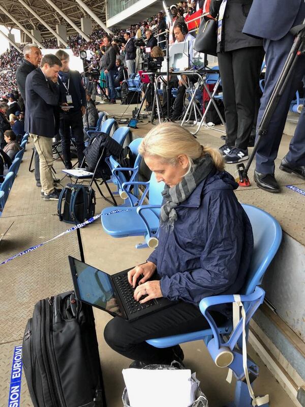 This photo provided by Delia Gallagher shows Associated Press correspondent Nicole Winfield covering a Mass celebrated by Pope Francis in Zimpeto Stadium, Maputo, Mozambique, on Sept. 6, 2019. (Delia Gallagher via AP)